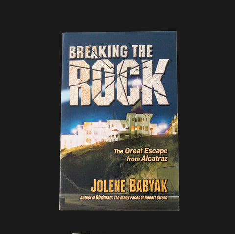 Front cover the book title "Breaking the Rock The Great Escape from Alcatraz" by Jolene Babyak with a night time photo of Alcatraz Island's lighthouse