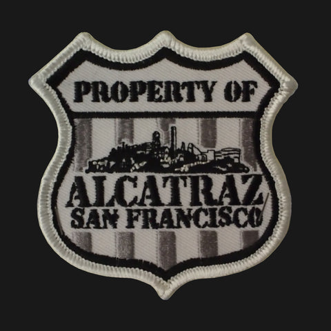 A police badge shape patch with Property of Alcatraz San Francisco" embroidered on it.