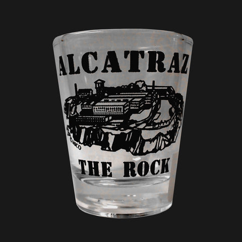 A clear shot glass with "Alcatraz The Rock" printed on the side