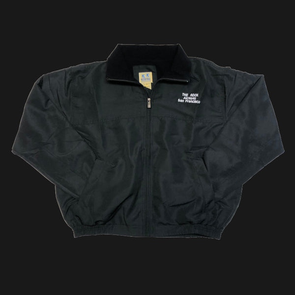 A soft shell fleece line wind breaker jacket in navy black with "The Pock Alcatraz San Francisco" logo on the front left chest