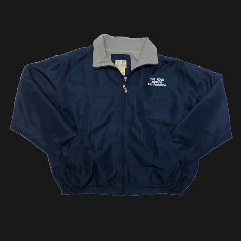 A soft shell fleece line wind breaker jacket in navy blue with "The Pock Alcatraz San Francisco" logo on the front left chest