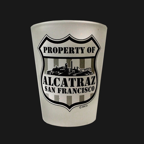 A frosted shot glass with "Property of Alcatraz San Francisco" printed on the side.