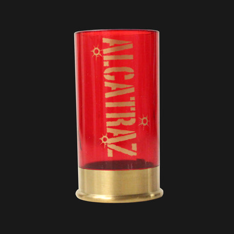 A shot gun shell shape shot glass with "Alcatraz" printed on the side of the shot glass