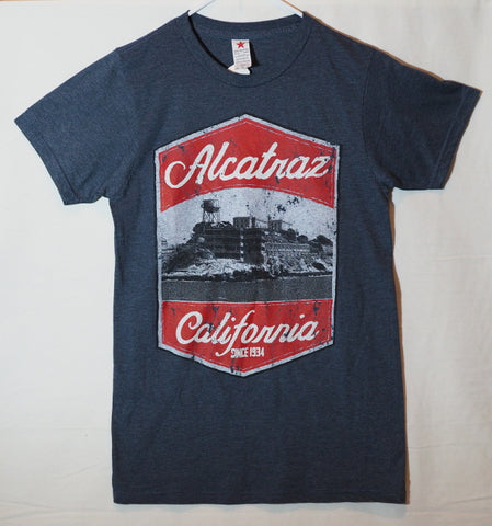 A navy color tee shirt with a picture of Alcatraz Island and Alcatraz California since 1934 silk screen printed on the front. 