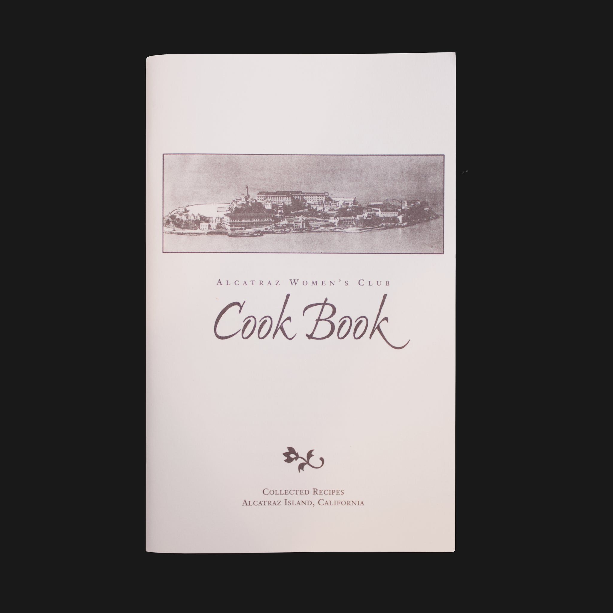 Front cover of Alcatraz Women's Club Cook Book with a black and white picture of Alcatraz Island.