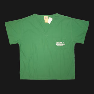 A green v-neck scrub short sleeves shirt with "Alcatraz psychiatric ward outpatient" on the left chest pocket.