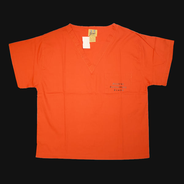 An orange color V-Neck short sleeves scrub shirt with Alcatraz Penitentiary printed on the left chest pocket.