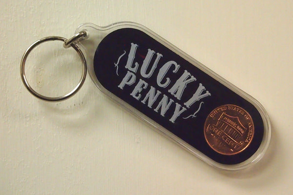 Back side view of an Oblong plastic key chain with "Lucky Penny" and US penny embedded inside.