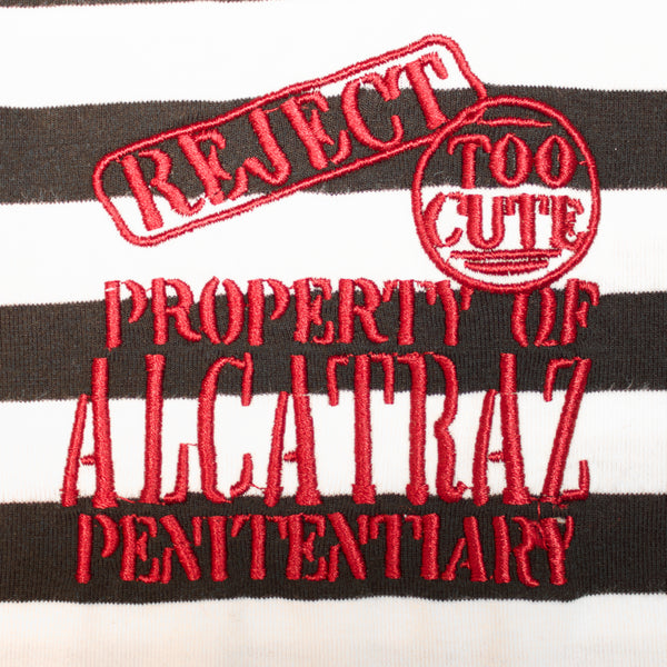 Close up of embroidered "Rejected Too Cute, Property of Alcatraz Penitentiary" logo