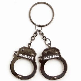 A handcuff shaped key chain with "Alcatraz" printed on the cuff