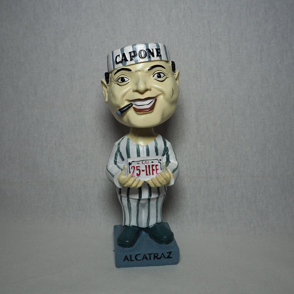 Al Capone bobble head holding a "25-Life" license plate. Front View