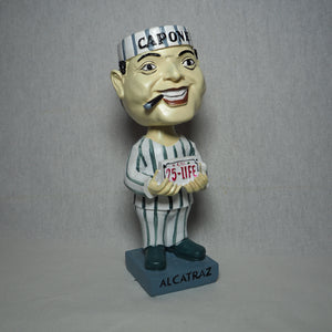 Al Capone bobble head holding a "25-Life" license plate