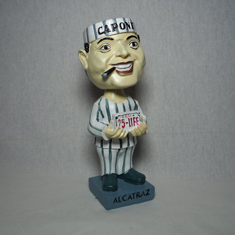 Al Capone bobble head holding a "25-Life" license plate